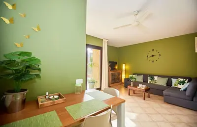 a living room with a table and a couch at Tropical Casa Verde Santa Maria G01 in Santa Maria