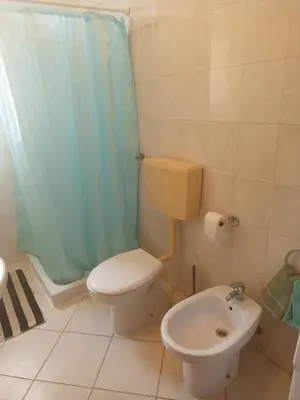 a bathroom with a toilet and a sink at Appartamento Teresa in Santa Maria