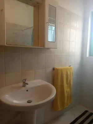 a bathroom with a sink and a mirror and a towel at Appartamento Teresa in Santa Maria