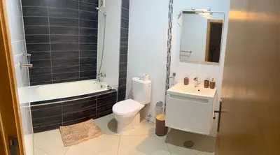 a bathroom with a white toilet and a sink at Kubiku Guest House in Praia