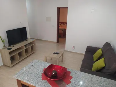 a living room with a couch and a table at Ladeira apartamentos in Ribeira Grande