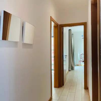 a hallway with two pictures on the wall and a door at Sal Little Heart Blue Apartment 13 in Santa Maria