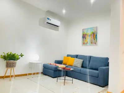 a blue couch in a living room with a table at Sal Little Heart Blue Apartment 13 in Santa Maria