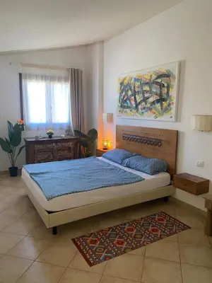 a bedroom with a bed and a painting on the wall at Tropical Miradouro in Santa Maria