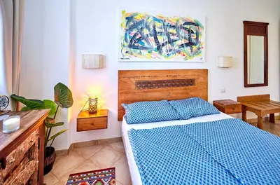 a bedroom with a bed and a painting on the wall at Tropical Miradouro in Santa Maria