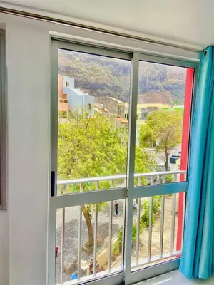 a window with a view of a mountain view at LAR DO VIAJANTE, Ribeira Grande Santo Antão in Ribeira Grande