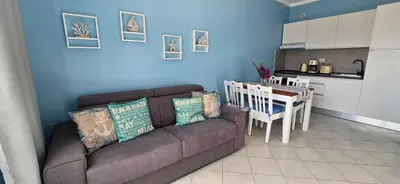 a living room with a couch and a kitchen at Ocean Breeze in Sal Rei