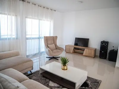 a living room with a couch and a coffee table at Appartement moderne avec vue sur la mer in Praia