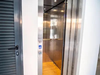 a elevator in a building with a glass door at Appartement moderne avec vue sur la mer in Praia