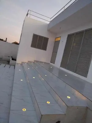 a white building with lights on the side of it at Residencia Moreno in Praia