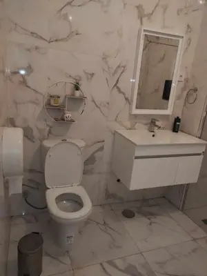 a bathroom with a toilet and a sink and a mirror at Residencia Moreno in Praia