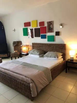 a bedroom with a large bed with colorful squares on the wall at Patys in Santa Maria
