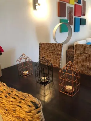 a table with four bird cages on top of it at Patys in Santa Maria