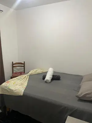 a bed with a stuffed animal on top of it at MeM Apartment in Praia