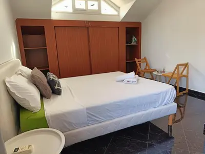 a bedroom with a bed and a table and chairs at Casa Miami in Tarrafal