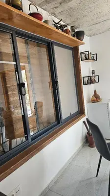 a window in a room with a table and a chair at Serene Escape in Porto Madeira in Sacramento