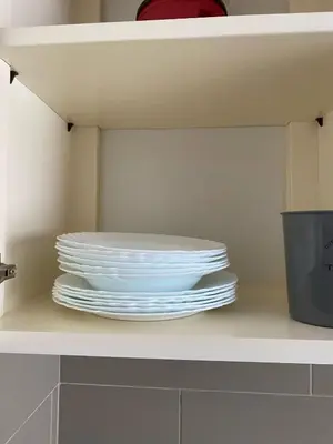 a stack of plates sitting on a shelf at KÁ Rui in Santa Maria