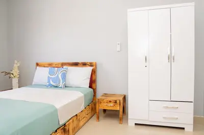 a bedroom with a bed and a dresser at J Martins Apart T11 Tarrafal in Tarrafal