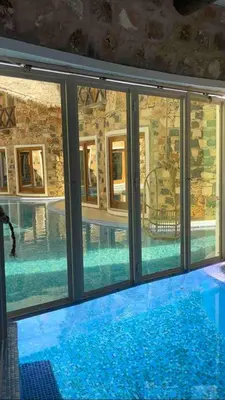 a large swimming pool with glass windows and a swimming pool at Suite and pool, Praia Estoril, Sal Rei in Sal Rei