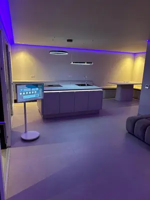 a kitchen with a sink and a table with purple lights at Sal Apartment in Mindelo