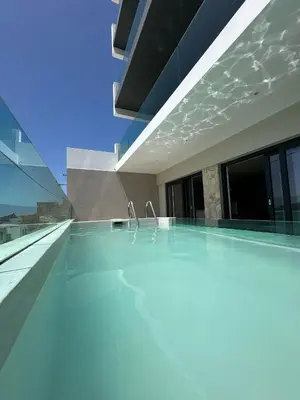 a swimming pool on the roof of a house at Sal Apartment in Mindelo
