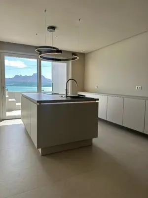 a kitchen with a large island with a large window at Sal Apartment in Mindelo