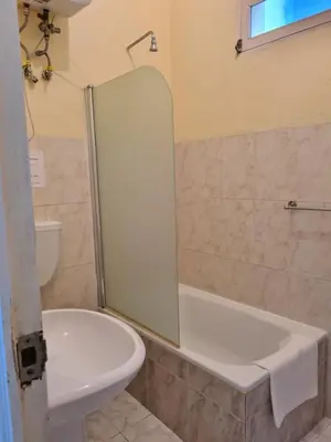 a bathroom with a shower and a toilet and a sink at Djarfogo house in São Filipe
