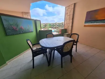 a table and chairs in a room with a window at Djadsal Moradias in Santa Maria