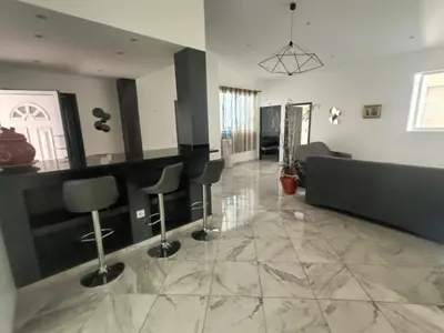 a living room with a couch and chairs in it at Casa Shell in Tarrafal