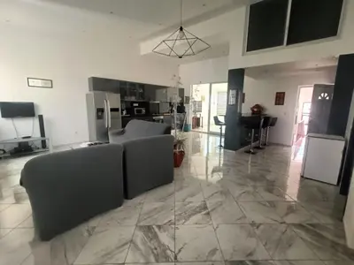 a living room with a couch and a kitchen at Casa Shell in Tarrafal