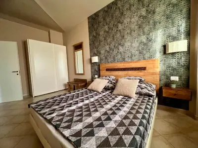 a bedroom with a bed with a black and white blanket at Tropical Morna in Santa Maria