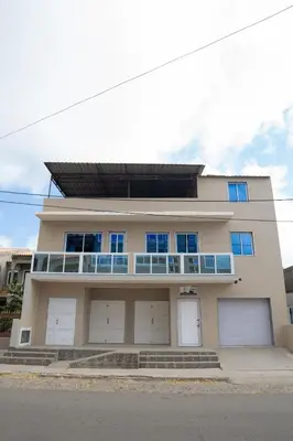 a house with four garage doors at J Martins ApartHotel in Tarrafal