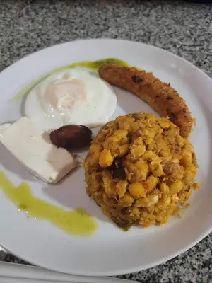 a plate of food with an egg and a cookie at Techas City Center Luxe Suites in Praia
