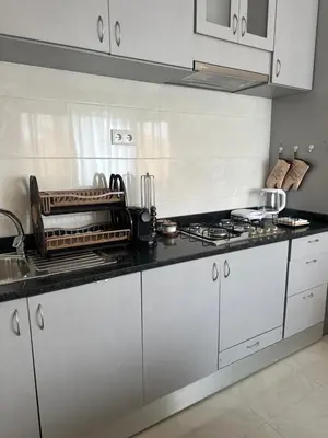 a kitchen with white cabinets and a counter top at T1 Mindelo City Center in Mindelo