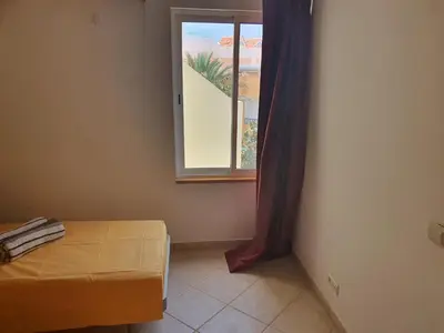 a room with a bed and a window at Capo Verde Club - Ca Francesca in Santa Maria
