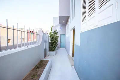 an empty hallway of a building with plants at Maya Mindelo 2 in Mindelo