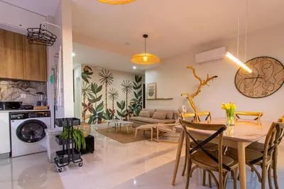 a dining room and living room with a table and chairs at HouseLux JJL in Mindelo
