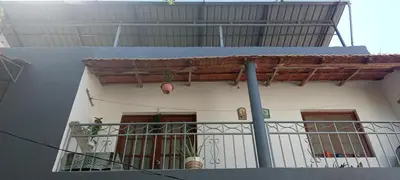 a white house with a balcony with plants on it at Holiday's House in Praia