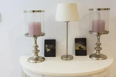 a shelf with two lamps and two books on it at Marel Bliss Apartments T2 Camila in Mindelo