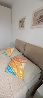 a bed with four pillows on top of it at Onda do Mar in Sal Rei