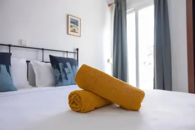 a towel animal on a bed in a bedroom at Marel Bliss Apartments T2 Lorena in Mindelo