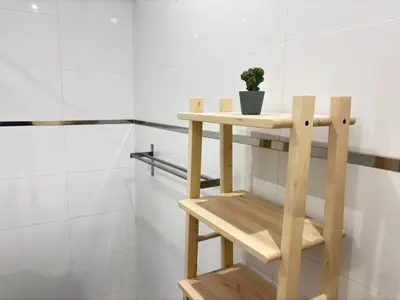 a wooden shelf in a bathroom with a potted plant at Relax in Praia in comfort in Praia