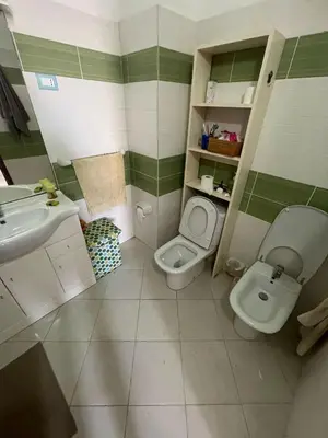 a bathroom with a toilet and a sink at Two Bedroom Apt - 150 meters from the Beach in Santa Maria