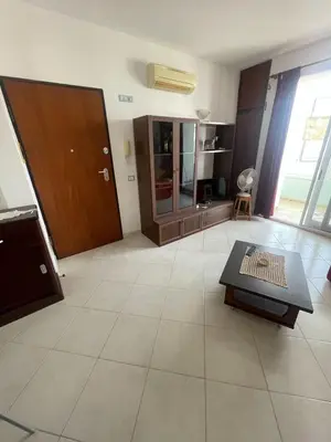 a large living room with a table and a door at Two Bedroom Apt - 150 meters from the Beach in Santa Maria