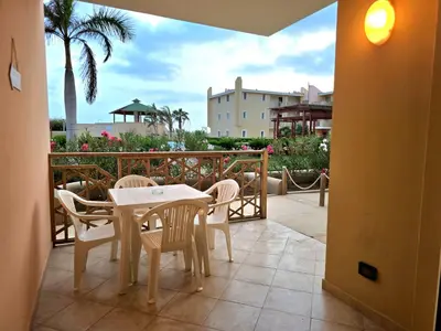 a patio with a table and chairs on a balcony at T&C No Stress apartment in Santa Maria