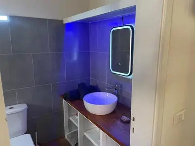 a bathroom with a sink and a mirror and a toilet at Island Retreat in Santa Maria