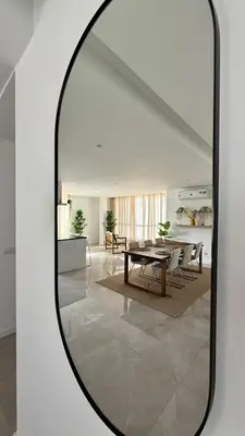 a mirror in a living room with a table and chairs at Laginha Paradise III in Mindelo