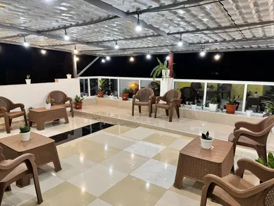 a lobby with chairs and tables in a building at Old Town view Apartment in Cidade Velha