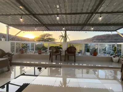 a patio with a table and chairs and a pool at Ocean view Apartment 2 in Cidade Velha