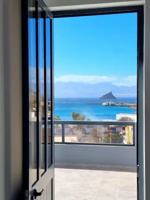 a view of the ocean from a balcony at R3 Apartments - Laginha in Mindelo